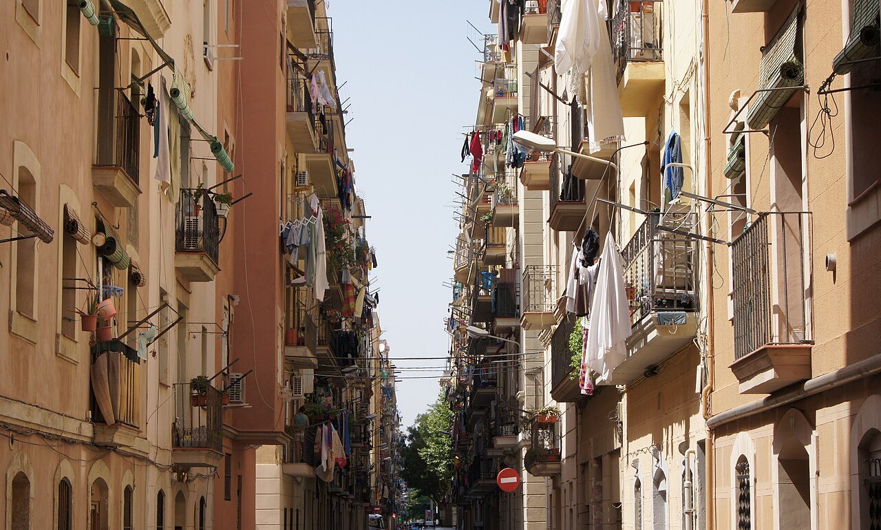 A narrow street in Barceloneta, with laundry hanging from the balconies.
