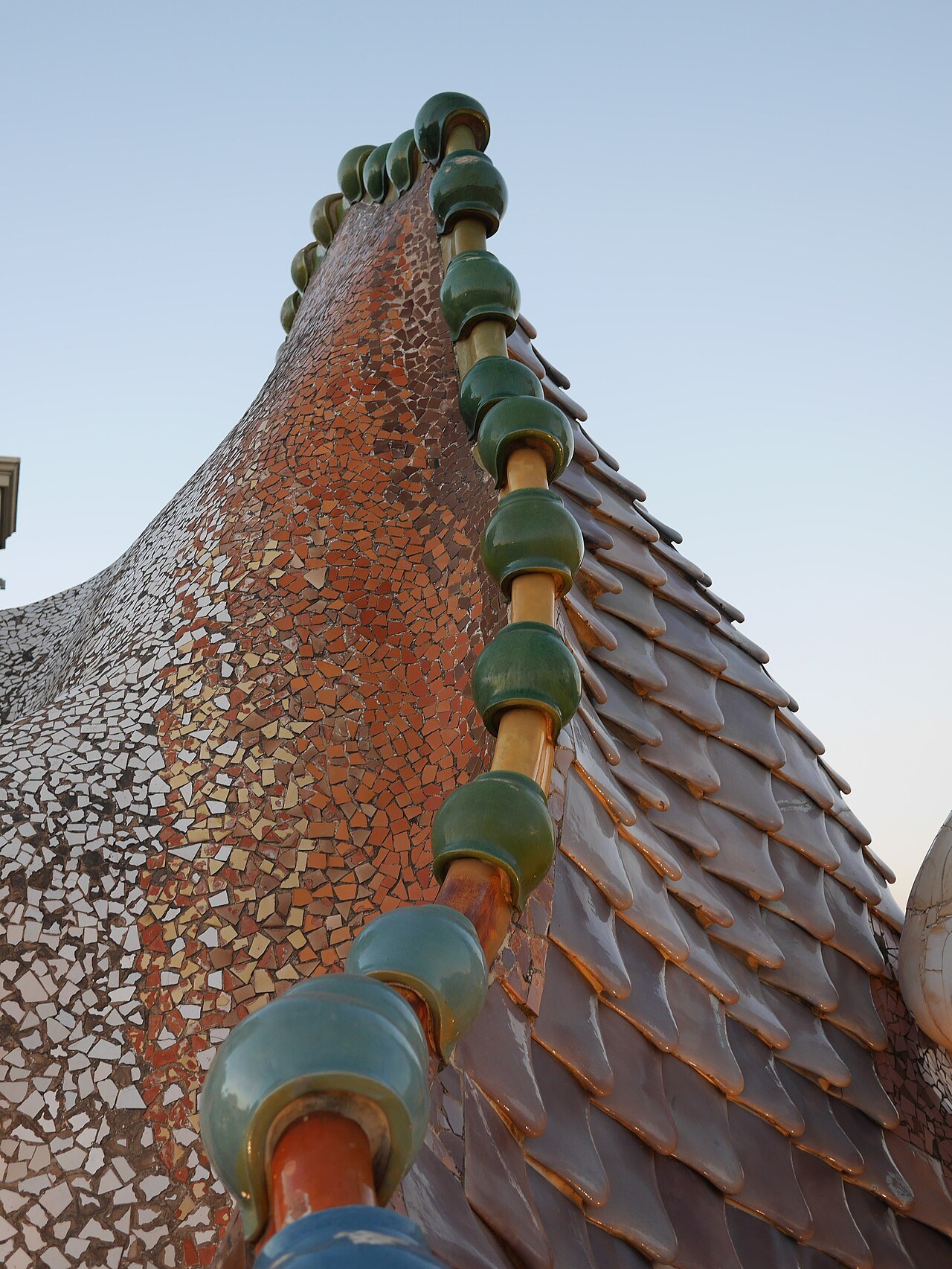 The scaled ridge of Casa Batlló's roof, curving up like the back of a dragon.