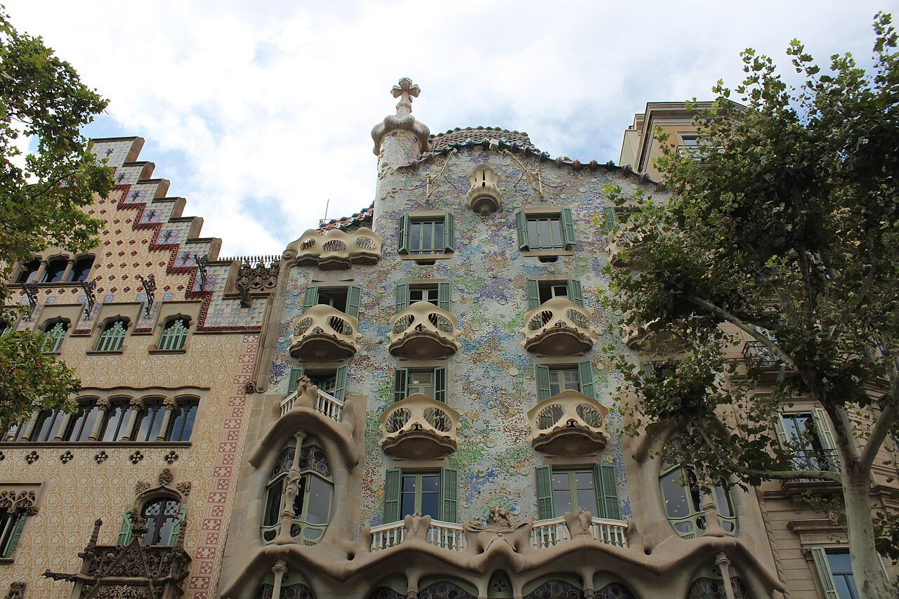 Casa Batlló's mosaic façade, with the stepped gable of Casa Amatller at its side.