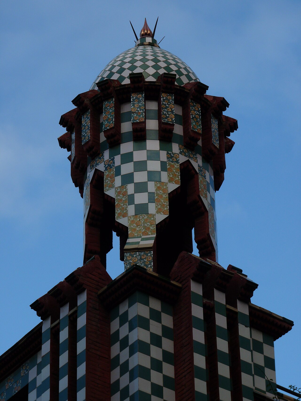 A cupola of black-and-white checkered tile topped with a spiked finial, at Casa Vicens.