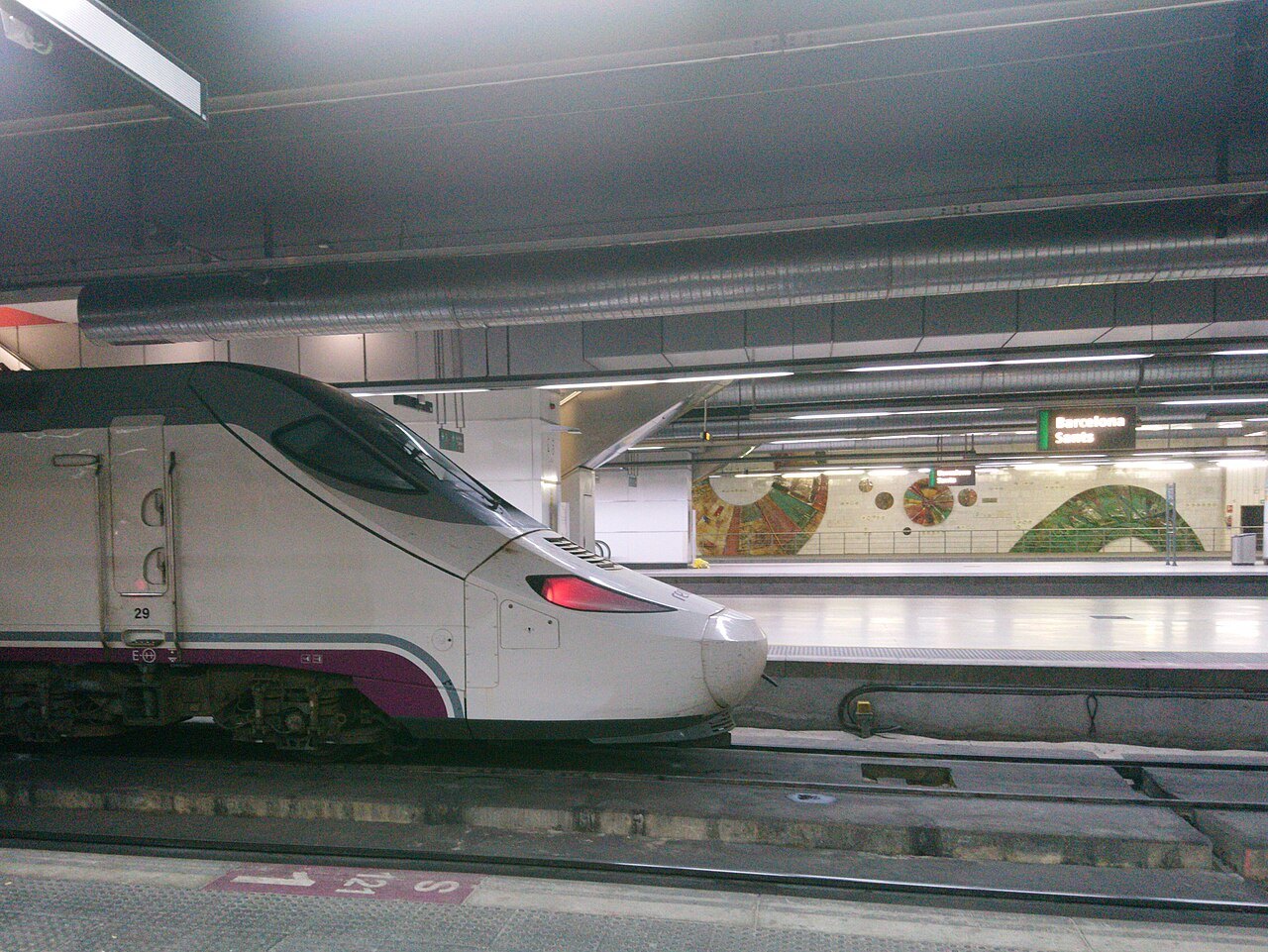 The nose of a high-speed train at a platform at Barcelona Sants.