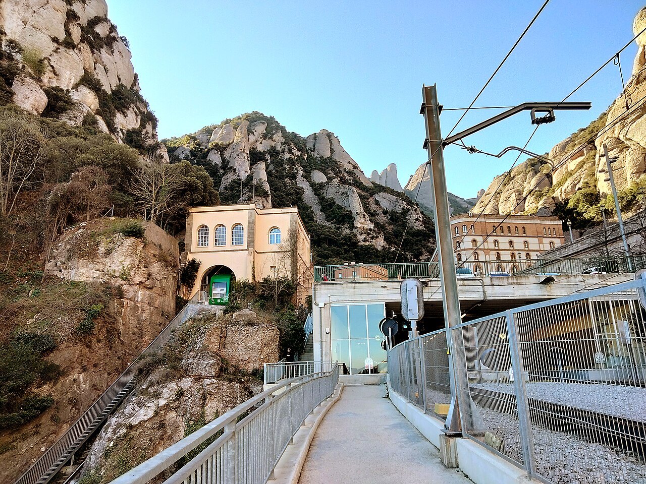 The upper station of the Santa Cova funicular, with the rack railway and the cliffs of Montserrat behind.