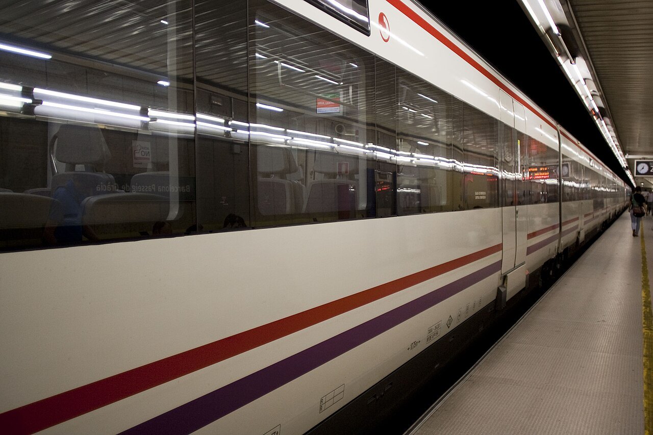 A long train standing at a metro platform.