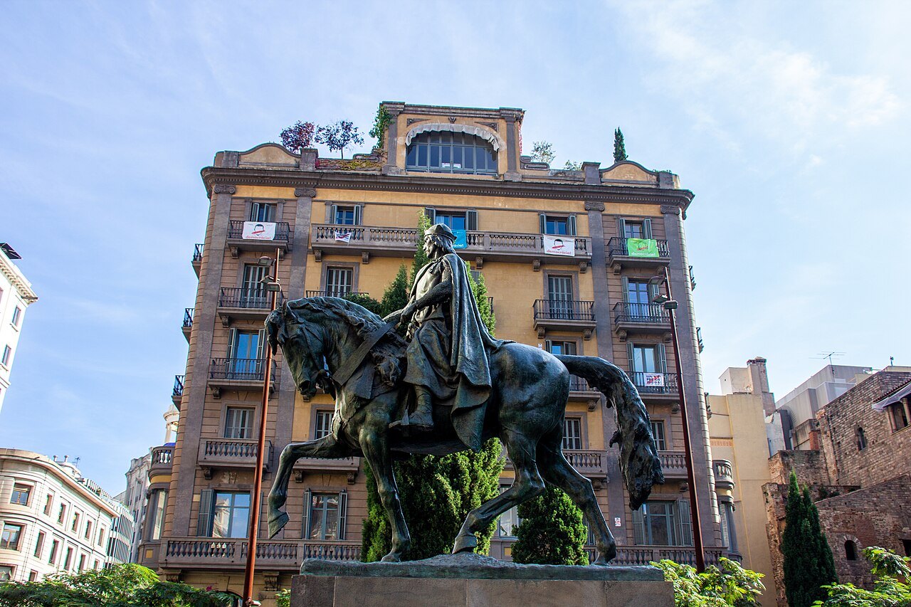 An equestrian statue in front of the same apartment building, at the edge of the old city.
