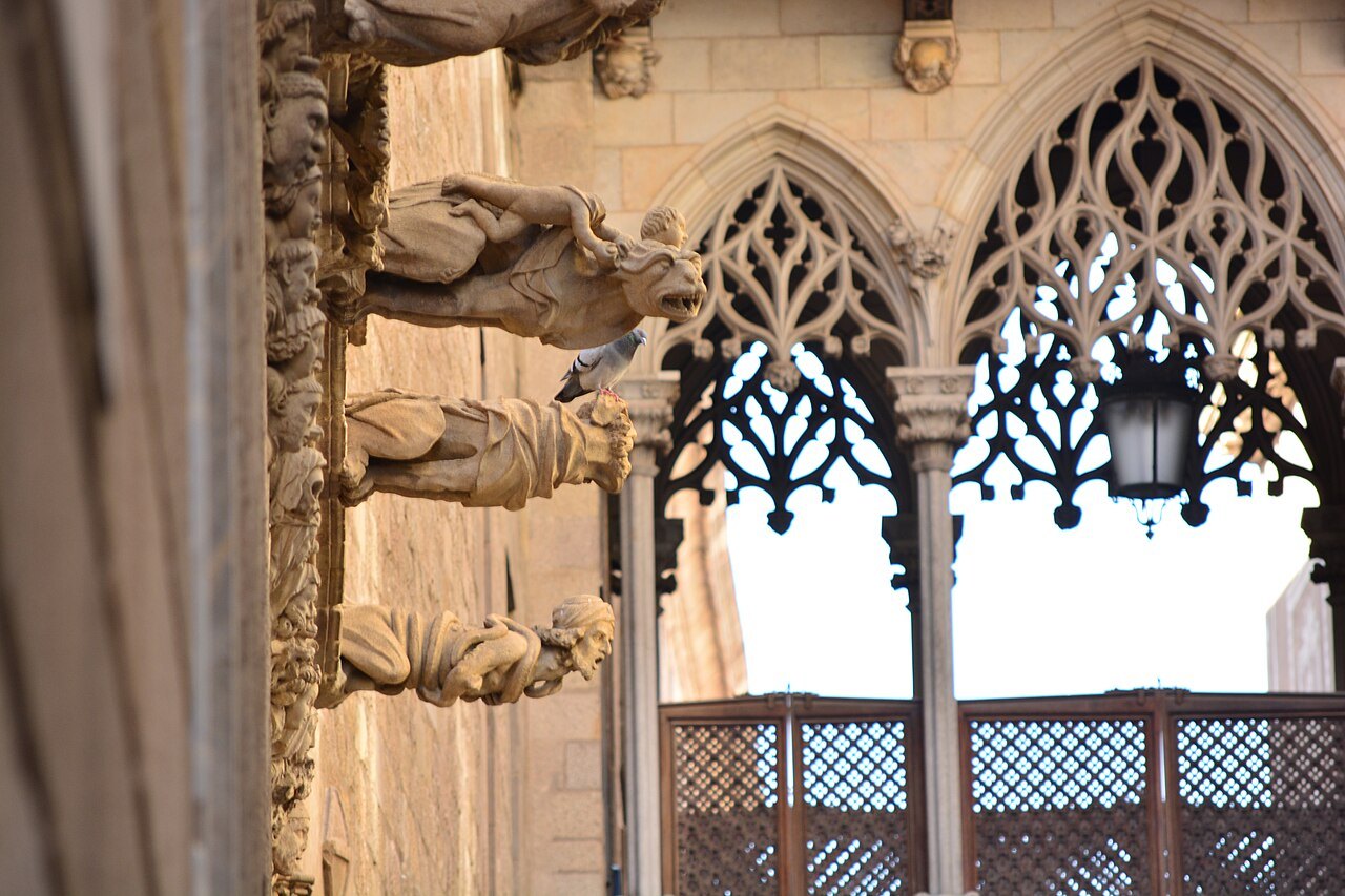 The tracery and stone gargoyles of the Palau de la Generalitat seen from the street.