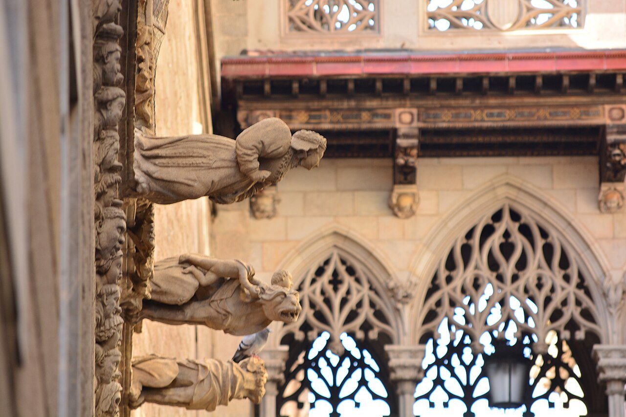 Gothic windows with tracery and gargoyles on the Palau de la Generalitat, on Carrer del Bisbe.