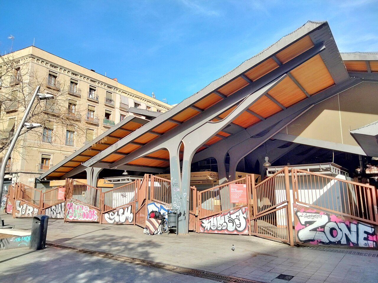The sweeping canopy at the market's entrance on its side street, with painted shutters below.