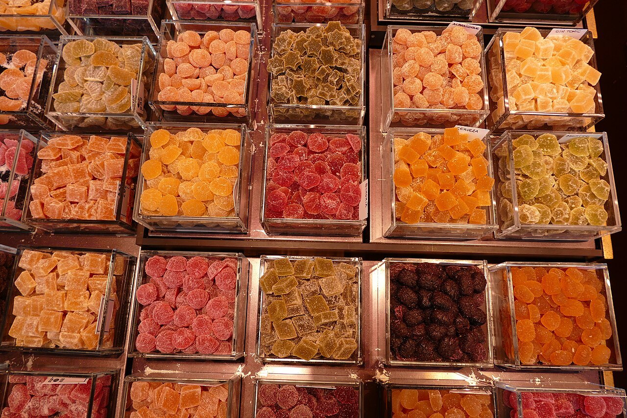 Boxes of candied fruit and jellies on a Boqueria stall.