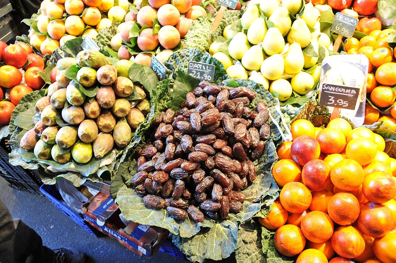 Pears, dates and oranges heaped on a stall in the Boqueria.