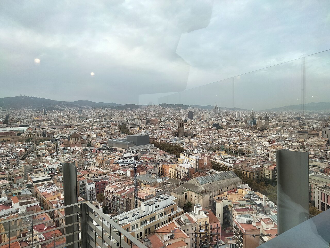 The city seen from a high tower, with the Raval and the Rambla in the haze.