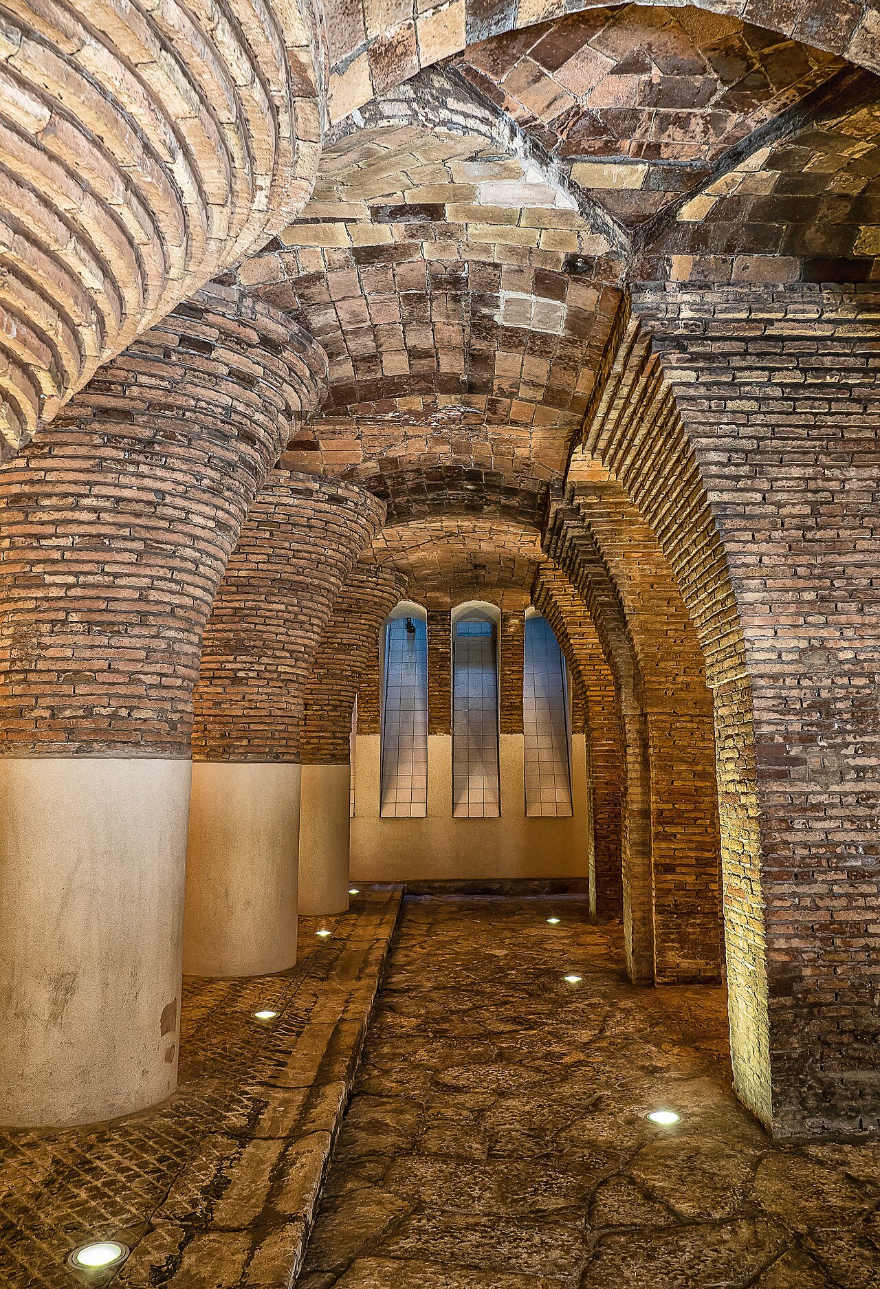 A narrow brick-vaulted passage at the Palau Güell.