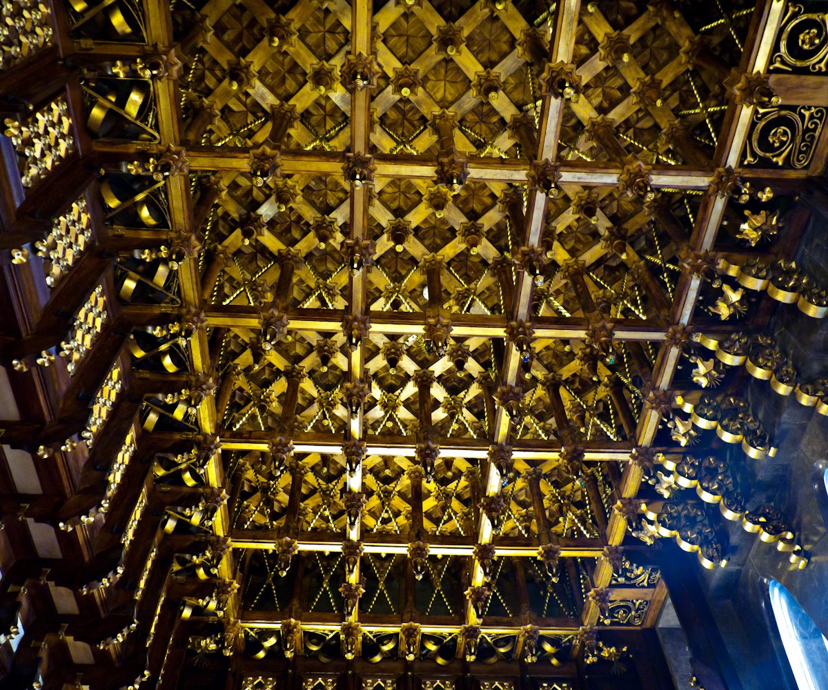 The gilded coffered ceiling of a room in the Palau Güell.