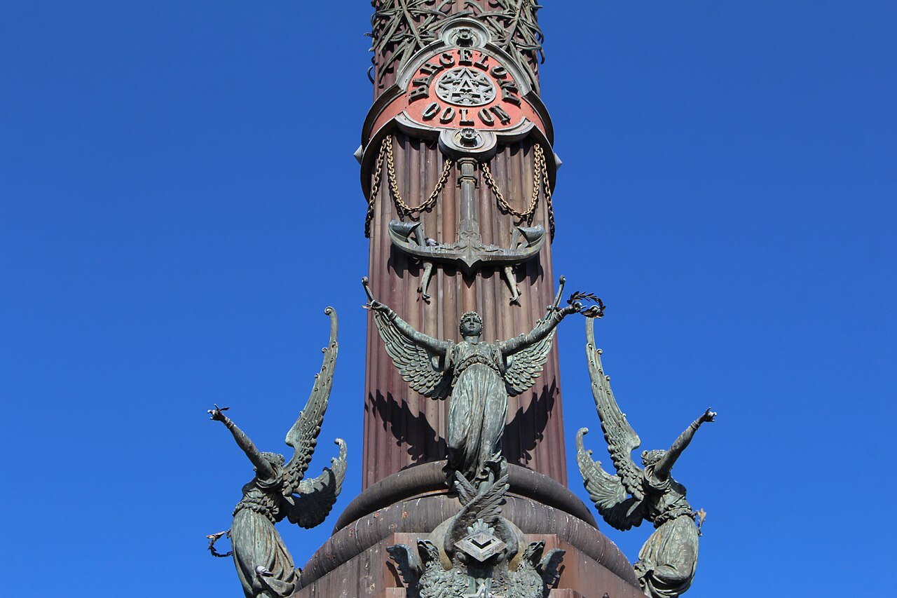The shaft of the Columbus Monument, with winged figures at its base.