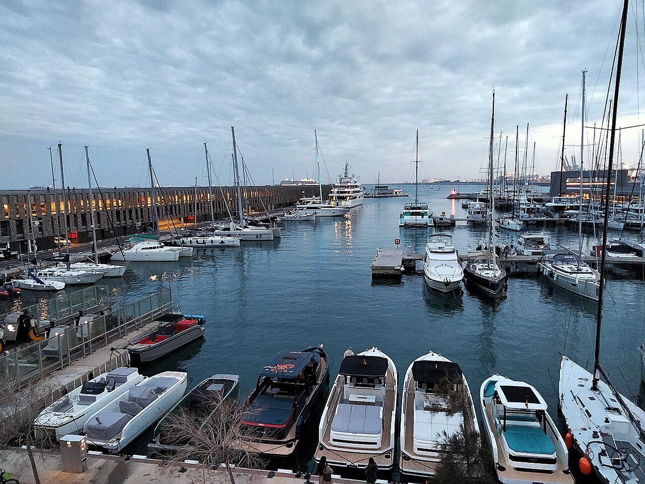 Motor boats and yachts moored in a marina on the Port Vell.