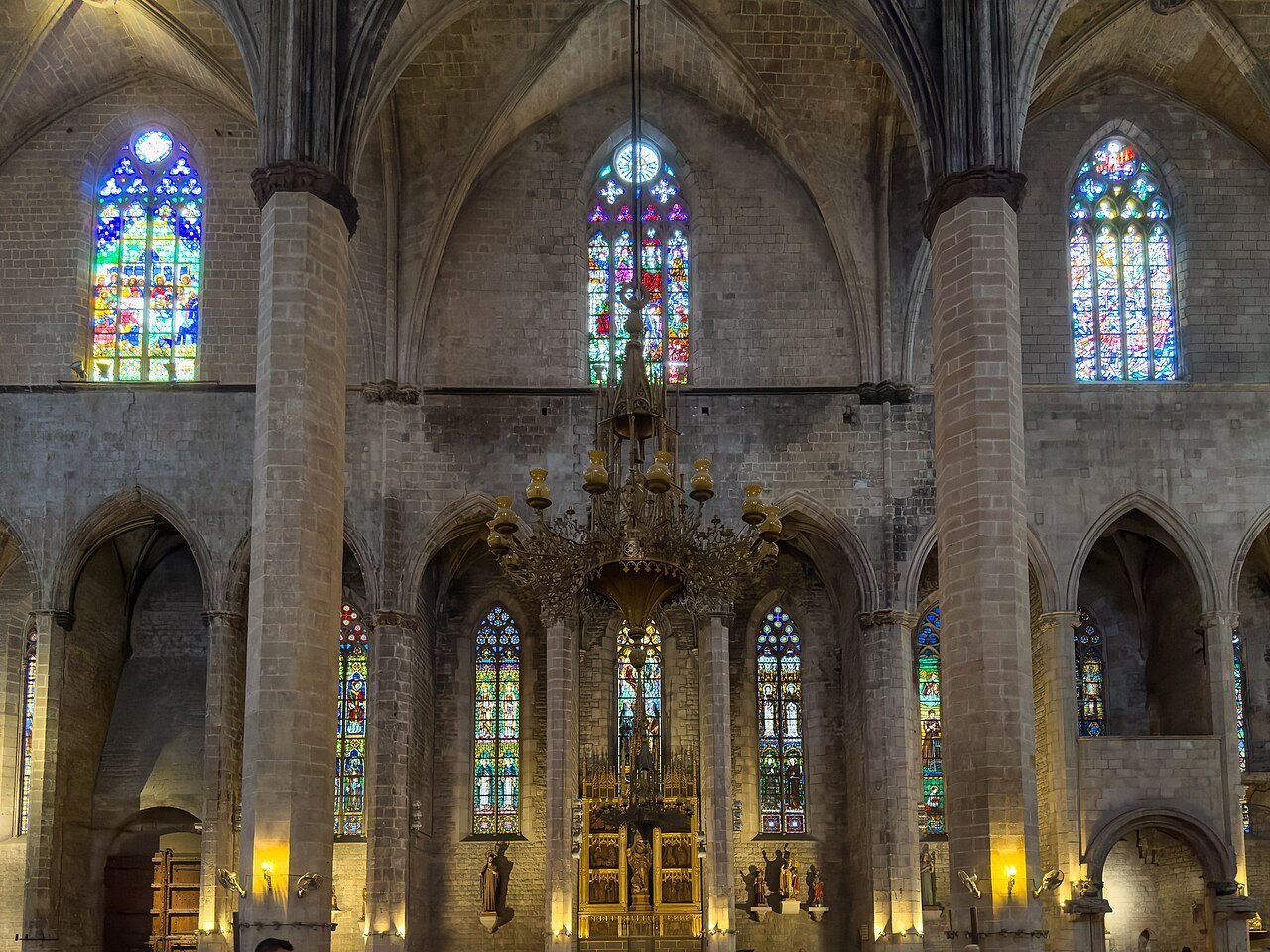 The nave of Santa Maria del Mar, slender columns and stained-glass windows.