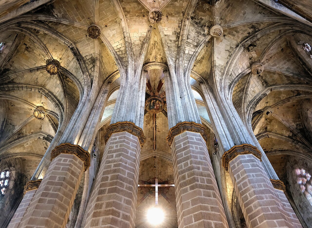 Brick columns rising into the ribbed vault of Santa Maria del Mar, seen looking up.