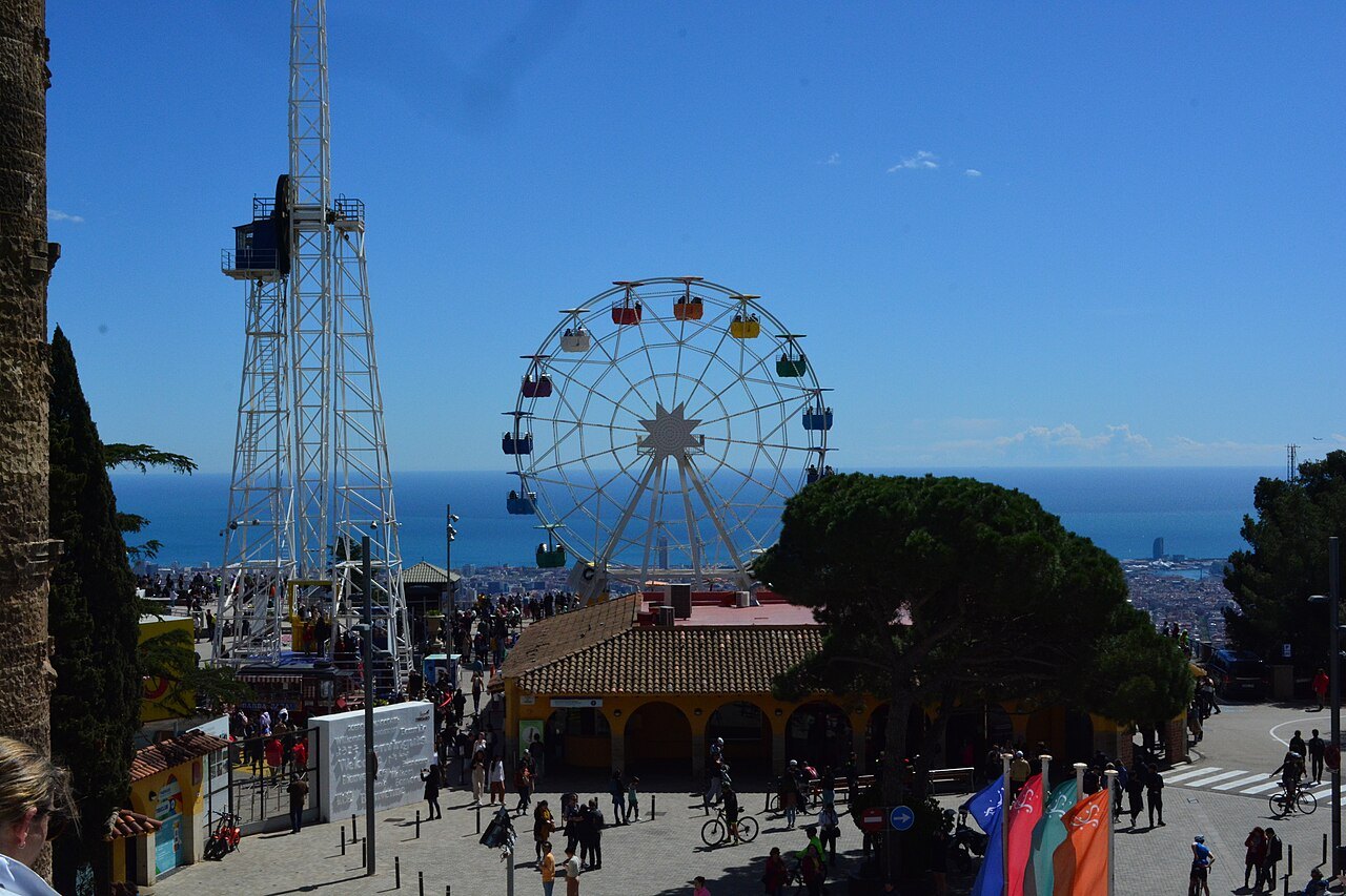 The Ferris wheel and a steel tower at Tibidabo, with the sea beyond.