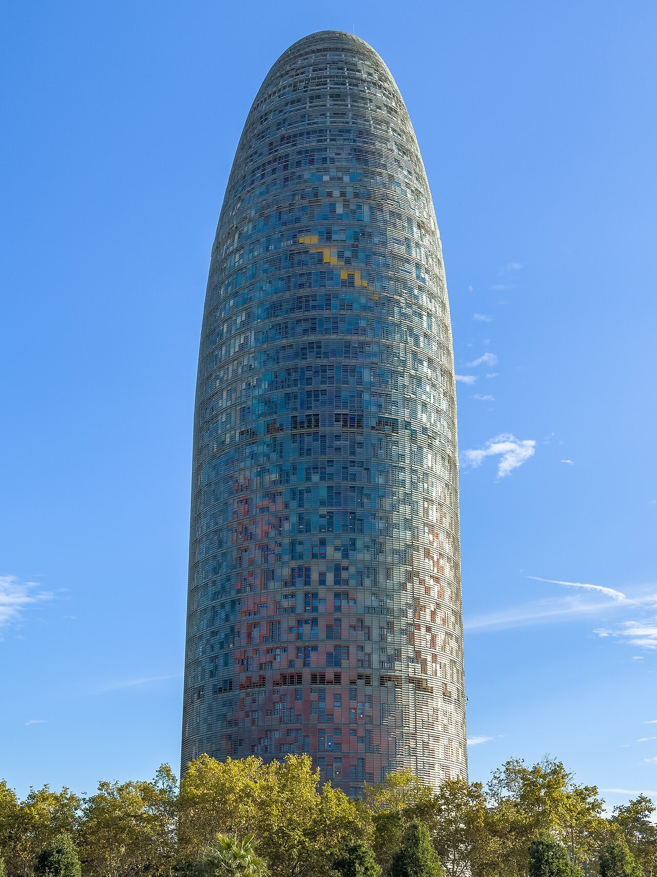 The Torre Glòries rising against a clear sky.