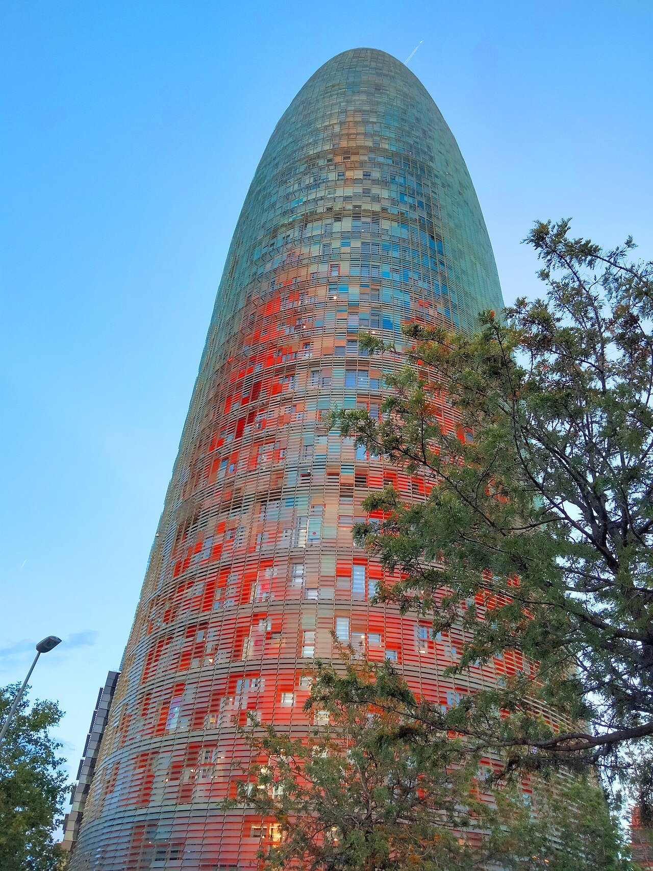 The red and blue panels of the Torre Glòries seen from close at the foot of the tower.